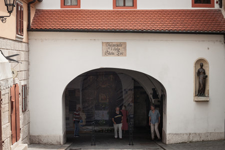 ZAGREB, CROATIA - JUNE 20, 2021: Tourists passing by Kamenita vrata, the Zagreb stone gate, a gate in the gornji grad upper town of the medieval city of Zagreb.のeditorial素材