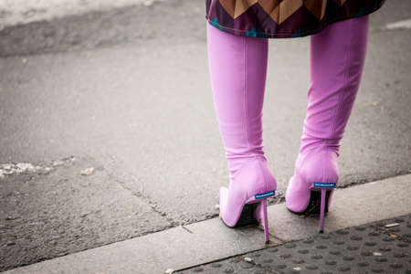 BELGRADE, SERBIA - OCTOBER 16, 2021: Selective blur on women purple boots with the logo of Balenciaga. Baleciaga is a Spanish luxury fashion designer specialized in footwear and clothing.のeditorial素材