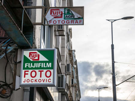 BELGRADE, SERBIA - NOVEMBER 28, 2021: Fujifilm logo on their retailer for Belgrade. Fujifilm, or Fuji, is a Japanese corporation specialized in photography, optics, office and medical electronics and digital imaging.のeditorial素材