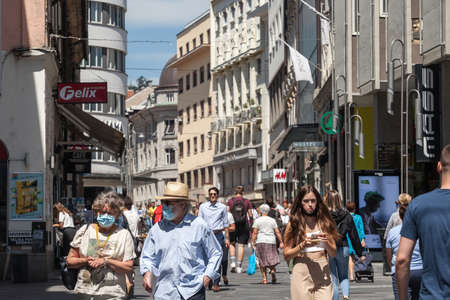 LJUBLJANA, SLOVENIA - JUNE 15, 2021: Selective blur on Old senior man and woman, couple, wearing a facemask, waking  in street of Ljubljana during coronavirus covid 19  crisis.のeditorial素材