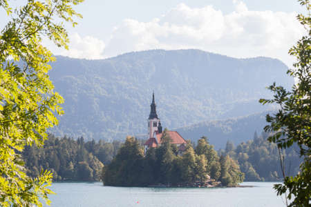 Selective blur on the Blejsko ostrvo, or bled island, on Bled lake or Blejsko Jezero, with the assumption of Maria church, or cerkev marijinega vnebovzetja. it's a catholic church and monument of Slovenia.の写真素材