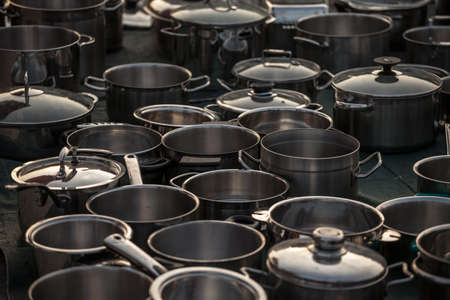 Selective blur on second hand kitchenware: metalware like pots and saucepans, pans, caldrons, in stainless steel and aluminum in the flea market of Obrenovacki Vasar.の写真素材