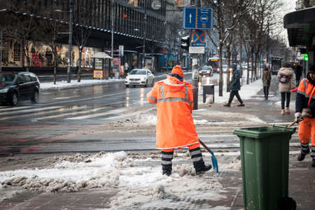BELGRADE, SERBIA - JANUARY 22, 2022: Selective blur on a man, a city worker from belgrade with fluo...