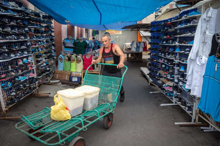 ODESSA, UKRAINE - AUGUST 13, 2015: Selective blur on a man, a merchant, wearing a tshirt with...