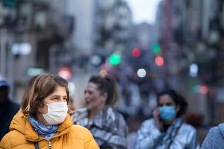BORDEAUX, FRANCE - FEBRUARY 24 2022: Selective blur on Old woman with facemask, walking in the crowded Sainte Catherine street in Bordeaux during coronavirus covid 19.のeditorial素材