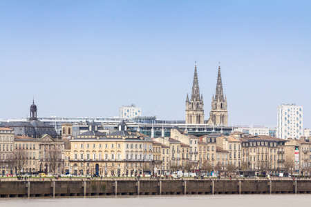 BORDEAUX, FRANCE - FEBRUARY 20, 2022: Panorama of the garonne quay (quais de la garonne), in Bordeaux, with the Saint Andre Cathedral behind during a winter afternoon.のeditorial素材