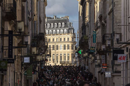 BORDEAUX, FRANCE - FEBRUARY 19, 2022: Selective blur on rue Sainte Catherine street crowded with people shopping, some wearing facemask during covid 19, it's one of most commercial areas of France.のeditorial素材