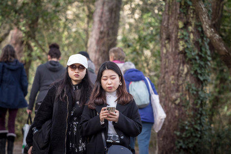 ARCACHON, FRANCE - FEBRUARY 22, 2022: Selective blur on Two young women, Asians, from Japan,...