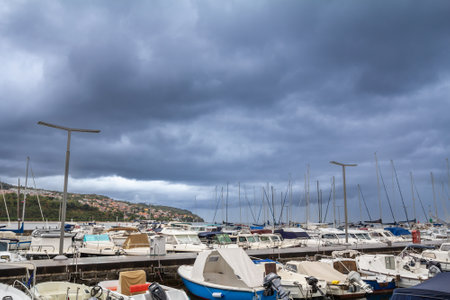 KOPER, SLOVENIA - SEPTEMBER 17, 2021: Panorama of the Koper marina, Svetilnik, with boats and ships anchored, on the adriatic sea, in Koper, Slovenia, during a rainy afternoon.のeditorial素材