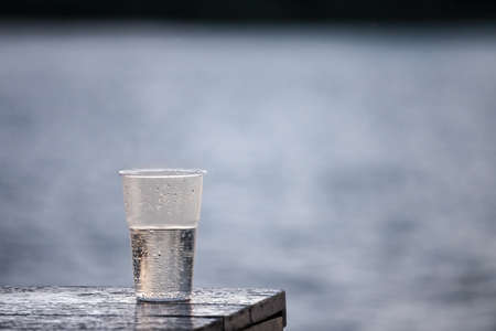 Selective blur on a plastic cup of sparkling water, outdoor.Sparkling water is a carbonated fizzy beverage.の写真素材