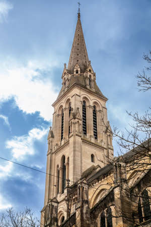 Steeple tower of the Eglise Notre Dame de bergerac church, the main catholic church, neogothic, built in the 19th century in Bergerac, a city of Dordogne, in Perigord, in France.の写真素材