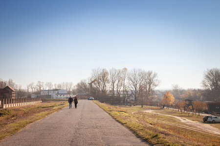 PANCEVO, SERBIA - NOVEMBER 21, 2021: Panorama of the Tamiski Kej, or Tamis Quay, with a middle aged couple walking together, in Pancevo, one of the cities of Banat, in Vojvodina.のeditorial素材