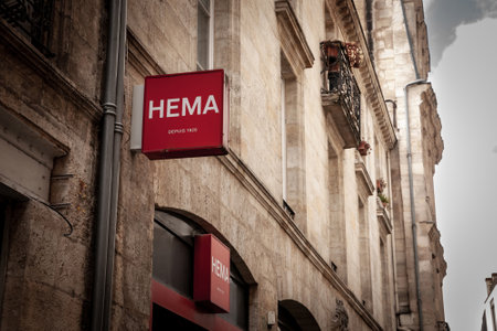 BORDEAUX, FRANCE - FEBRUARY 24, 2022: Hema Logo in front of their shop for Bordeaux. Hema is a Dutch variety store chain selling mostly accessories and toys and home goods.のeditorial素材