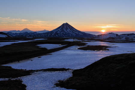 Volcanic landscape of Kamchatka: beautiful sunrise over Viluchinsky Volcano. Russia Far East Kamchatka Peninsula.の写真素材