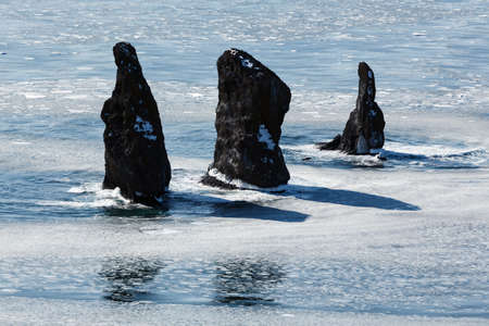 Beautiful landscape of Kamchatka: winter view on Three Brothers Rocks in Avachinskaya Bay Avacha Bay on a sunny day. Far East Russia Kamchatka Peninsula.の写真素材