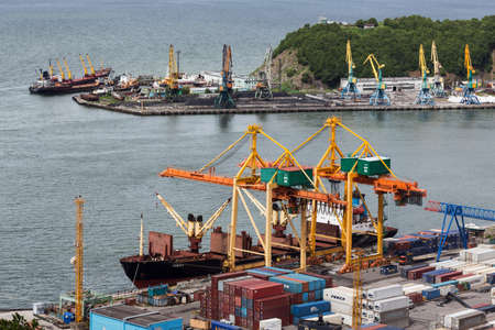 PETROPAVLOVSK-KAMCHATSKY, KAMCHATKA, RUSSIA - JULY 08, 2013: View on ships at the pier and port cranes on commercial seaport Petropavlovsk-Kamchatsky. Russia, Far East, Kamchatka Peninsula, Avachinskaya Bay.のeditorial素材