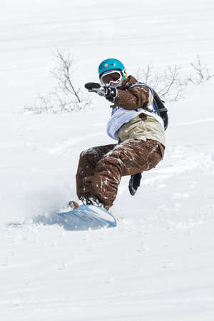 KAMCHATKA, RUSSIA - MARCH 9, 2014: Snowboarder rides steep mountains. Competitions freeride skiers and snowboarders "Kamchatka Freeride Open Cup". Russia, Far East, Kamchatka Peninsula.のeditorial素材