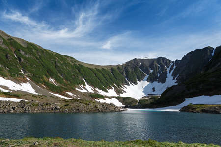 Beautiful mountain landscape: Blue Lake a comprehensive natural heritage of Kamchatka Peninsula. Summer view of the picturesque lake in the mountains on a sunny day. Russia Far East.の写真素材