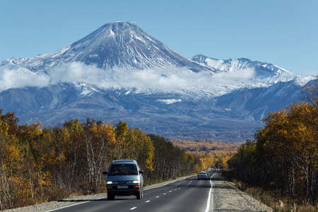 KAMCHATKA, RUSSIA - SEPTEMBER 30, 2012: Autumn view of the cars on the road to the active Avacha Volcano on Kamchatka Peninsula on a sunny, cloudless day with blue skies. Russian Federation, Far East.のeditorial素材