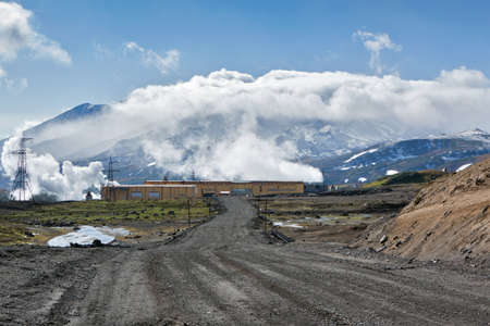MUTNOVSKY VOLCANO, KAMCHATKA, RUSSIA - SEP 21, 2011: View of the road to Mutnovskaya Geothermal Power Station on background active Mutnovsky Volcano. Eurasia, Russia, Far East, Kamchatsky Krai.のeditorial素材