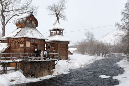 ESSO VILLAGE, KAMCHATKA PENINSULA, RUSSIA - MARCH 09, 2013: Winter view of the wooden building Bystrinsky Ethnographic Museum in Bystrinsky Region Kamchatka Krai on the river bank. Eurasia, Russian Far East.のeditorial素材