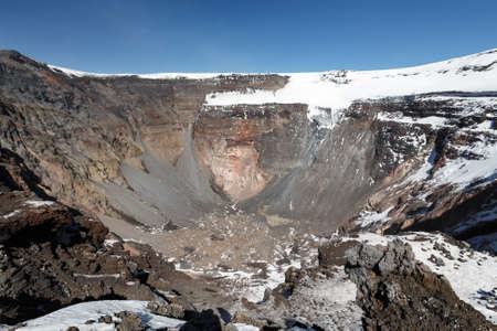 Volcanic landscape of Kamchatka Peninsula: view of large summit crater of active Tolbachik Volcano with steep sides and glaciers. Russian Far East, Kamchatka Region, Klyuchevskaya Group of Volcanoes.の写真素材