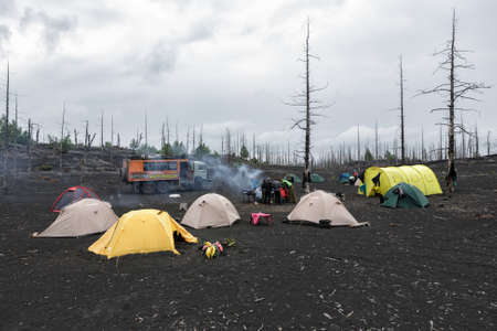 KAMCHATKA PENINSULA, RUSSIA - June 25, 2014: Tourist campground in Dead Wood on volcanic slag and ash eruptions Tolbachik Volcano - consequence of catastrophic eruption of volcano during on 1975-1976.のeditorial素材
