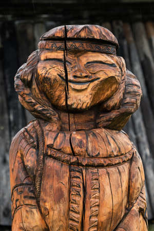 ESSO VILLAGE, KAMCHATKA PENINSULA, RUSSIA - SEP 18, 2013: Traditional wood carving - wooden sculpture of young woman Even - indigenous inhabitant of Kamchatka Peninsula. Bystrinsky Ethnographic Museumのeditorial素材