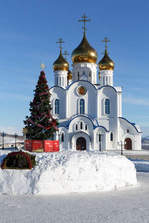 PETROPAVLOVSK CITY, KAMCHATKA PENINSULA, RUSSIA - JAN 6, 2018: Holy Trinity Orthodox Cathedral of Petropavlovsk, Kamchatka Diocese of Russian Orthodox Church and Christmas tree in front of buildingのeditorial素材