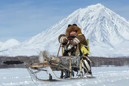 KAMCHATKA, RUSSIA - FEB 25, 2017: Kamchatka musher Mandyatov Roman dressed in national clothes rides on traditional sled of indigenous peoples of Kamchatka. Kamchatka Sled Dog Racing Beringia, Russian Cup of Sled Dog Racing (snow disciplines)のeditorial素材