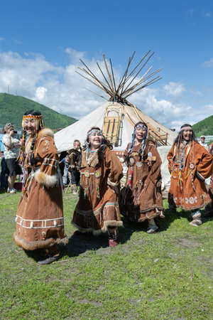 PETROPAVLOVSK CITY, KAMCHATKA PENINSULA, RUSSIA - JULY 11, 2015: Group of women in national clothing aborigine of Kamchatka expression dancing near yaranga. Public concert national folklore dance group on Fishermans Dayのeditorial素材