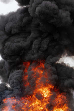 Huge flames of red-orange fire, motion clouds of dark smoke covered sky. Selective focus, motion blur, haze from strong fire and high temperature from flames.の写真素材