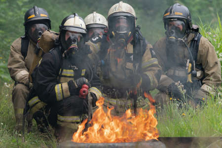 PETROPAVLOVSK-KAMCHATSKY, KAMCHATKA PENINSULA, RUSSIA - AUG 7, 2019: Firefighters of Fire Department â 1 of Federal Fire Service in Kamchatka during fire extinguishing, training to overcome fire zone of psychological training for firefighters.のeditorial素材