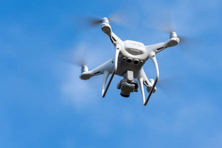 DJI Phantom 4 Pro quadcopter drone with digital camera 4K flight in deep blue sky, takes pictures world around from bird's eye view. Kamchatka Peninsula, Russian Federation at September 12, 2019のeditorial素材
