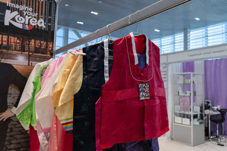 Hanbok - women traditional Korean dress vibrant colors for attire during traditional occasions: celebrations, festivals, ceremonies. Dress hanging on clothes hanger. Kamchatka, Russia - Oct 17, 2019のeditorial素材
