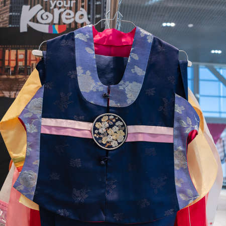 Hanbok - women traditional Korean dress vibrant colors for attire during traditional occasions: celebrations, festivals, ceremonies. Dress hanging on clothes hanger. Kamchatka, Russia - Oct 17, 2019のeditorial素材