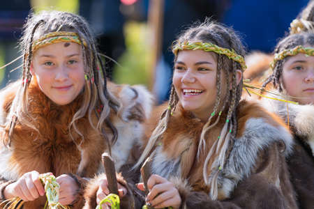 Two expression smiling girls in traditional clothing aboriginal of Kamchatka Peninsula. Itelmens national ritual festival of thanksgiving nature Alhalalalay. Kamchatka, Russian Far East - Sep 14, 2019のeditorial素材