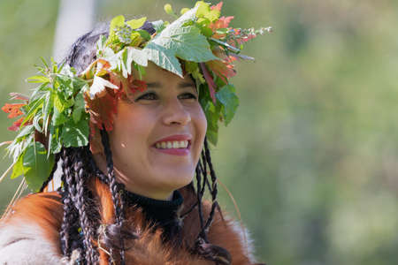 Portrait of smiling young woman in clothing aborigine of Kamchatka Peninsula. Itelmens national ritual festival of thanksgiving nature Alhalalalay. Kamchatka Region, Russian Far East - Sep 14, 2019のeditorial素材