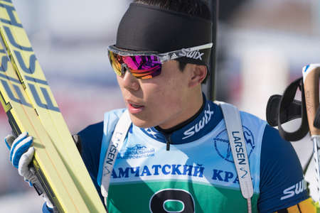 Portrait of Korean sportsman biathlete Yang Seon Jik South Korea at finish after rifle shooting and skiing. Junior biathlon competitions East of Cup. Kamchatka, Russian Far East - April 14, 2019.のeditorial素材