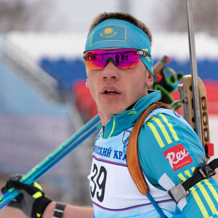 Portrait of sportsman biathlete Vladislav Kireyev Kazakhstan at finish after skiing and rifle shooting. Junior biathlon competitions East of Cup. Kamchatka Peninsula, Russian Far East - April 12, 2019のeditorial素材