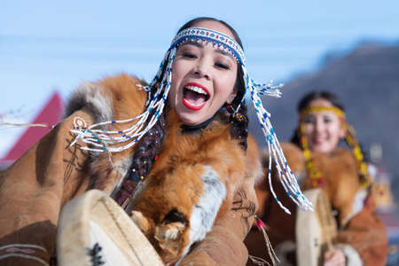 Female dancing with tambourine in national clothing indigenous inhabitants Kamchatka. Concert, celebration Koryak national holiday Day of Seal - Hololo. Kamchatka Peninsula, Russia - November 4, 2018のeditorial素材