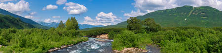 Panorama view of beautiful summer landscape - stream water of mountain river and green forest on...