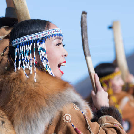 Female dancing with tambourine in tradition clothing aboriginal people of Kamchatka. Concert celebration Koryak national ritual holiday Hololo - Day of Seal. Kamchatka Peninsula, Russia - Nov 4, 2018のeditorial素材