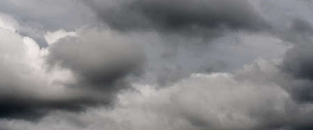 Scenery panoramic view of thunderstorm clouds in dusk sky during rain. Dramatic panorama of natural...