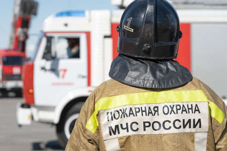 Back view of inscription Emercom of Russia on uniform firefighter of Ministry of Civil Defence,...