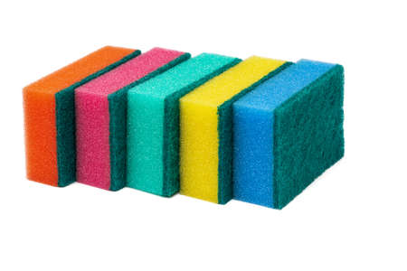 Group of foam sponges with abrasive material used by housewives who care about cleanliness in their favorite kitchen. Five orange, pink, green, yellow and blue colors sponges on white backgroundの写真素材
