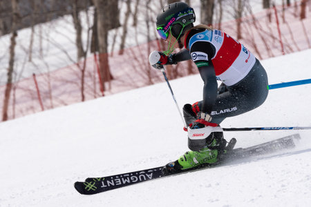 KAMCHATKA PENINSULA, RUSSIAN FAR EAST - MARCH 28, 2019: International Ski Federation Championship, slalom. Mountain skier Maria Shkanova Belarus skiing down mountain slope during winter competitionのeditorial素材