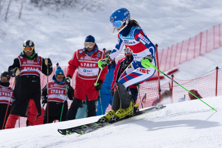 Mount skier Daria Shustrova Saint Petersburg skiing down mount slope. Russian Alpine Skiing Cup, International Ski Federation Championship, slalom. Kamchatka Peninsula, Russia - March 29, 2019のeditorial素材