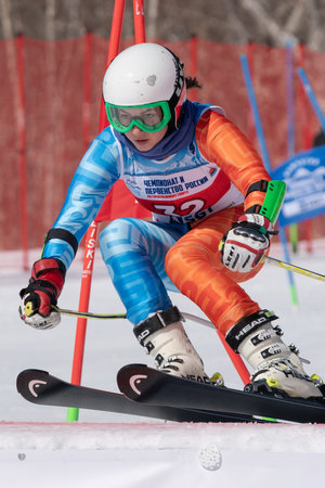 Sakhalin sportswoman mountain skier Fugleva Victoria skiing down mount slope parallel slalom. Russian Federation Alpine Skiing Championship. Kamchatka Peninsula, Russian Far East - March 30, 2019.のeditorial素材