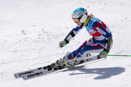 KAMCHATKA PENINSULA, RUSSIAN FEDERATION - APRIL 1, 2019: Mountain skier Fedorova Ksenia Moscow skiing down snowy mountain slope. Russian Women's Alpine Skiing Championship, giant slalom.のeditorial素材